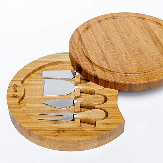 Bamboo cheese board set with four utensils on a white background