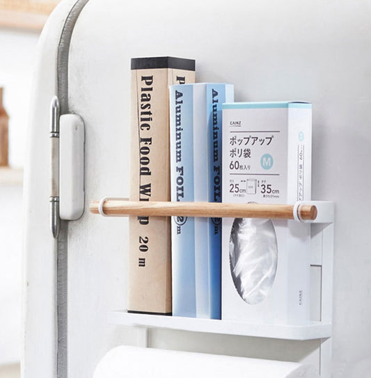 Small white shelf with books and a roll of paper towels against a light gray background