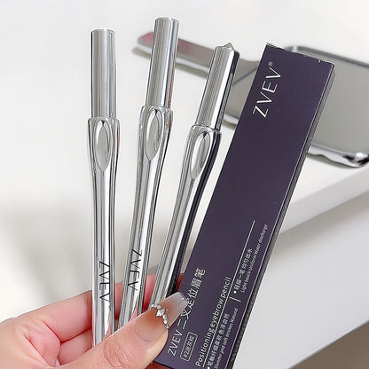 Three silver eyebrow pencils held by a hand with a blurred background