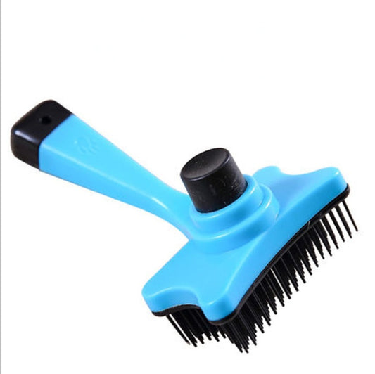 Blue pet grooming brush with black bristles on a white background