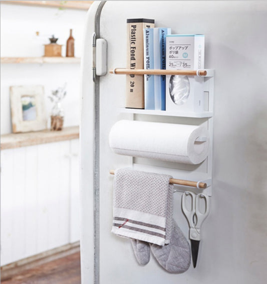 Wall-mounted organizer attached to a refrigerator with books, paper towels, and kitchen items.